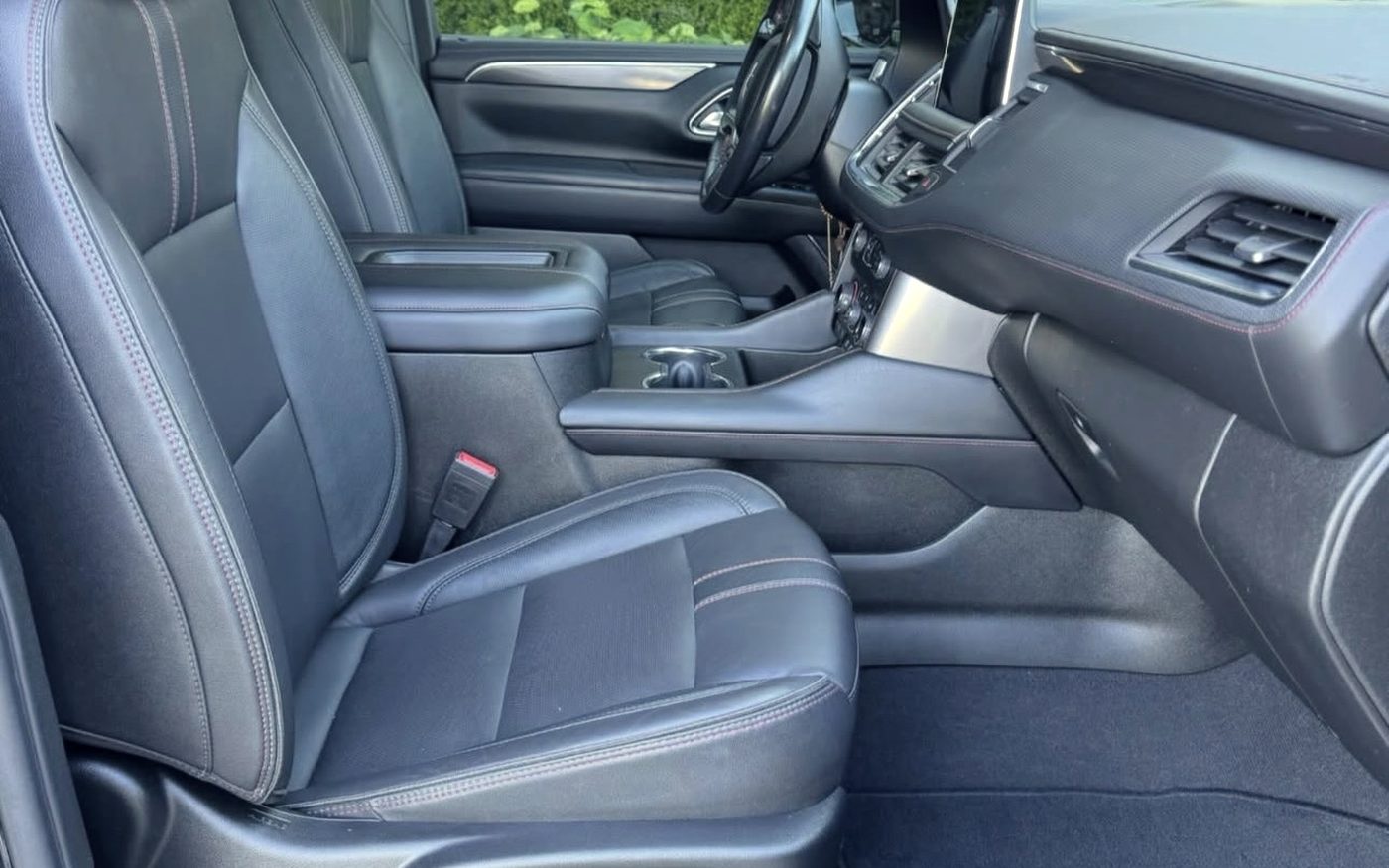 Chevrolet Tahoe front cabin, black leather seats and console cleaned and conditioned